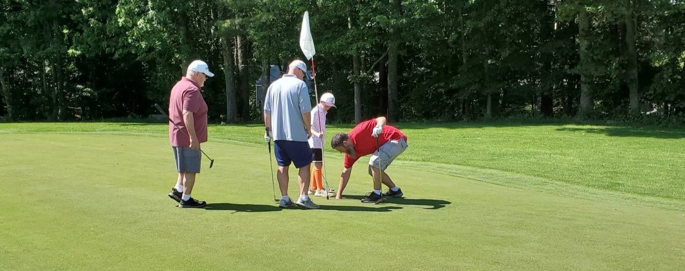 Residents on the green at Royal Crest on a summer afternoon
