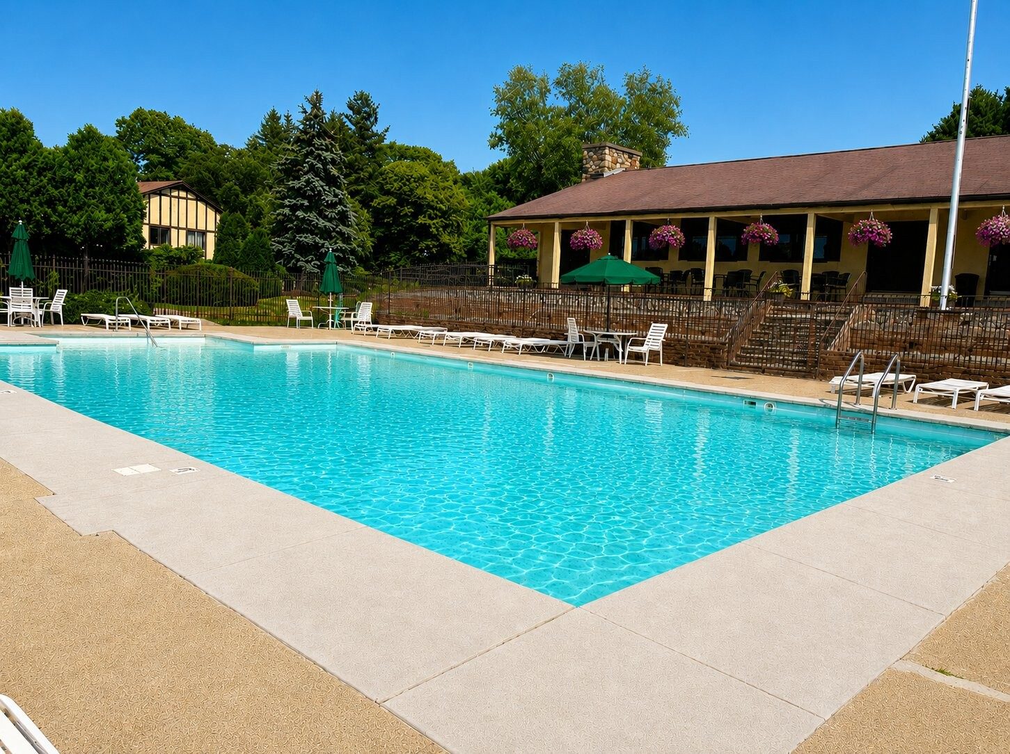 The Royal Crest pool on a sunny day with the clubhouse beyond